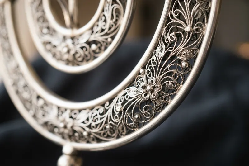 Macro detail of handmade sterling silver filigree in floral patterns.